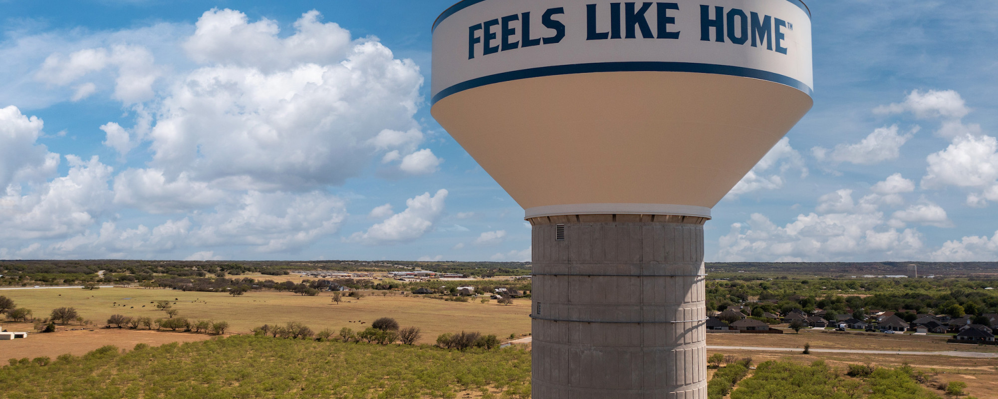 brownwood water tower that say "feels like home" with brownwood in the background